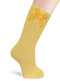 Meias caneladas altas com laço de cetim volumoso Mustard
